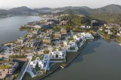 Dongqian Lake Club Houses: Five white residential buildings on the lake shore, with a black facated museum in the background.